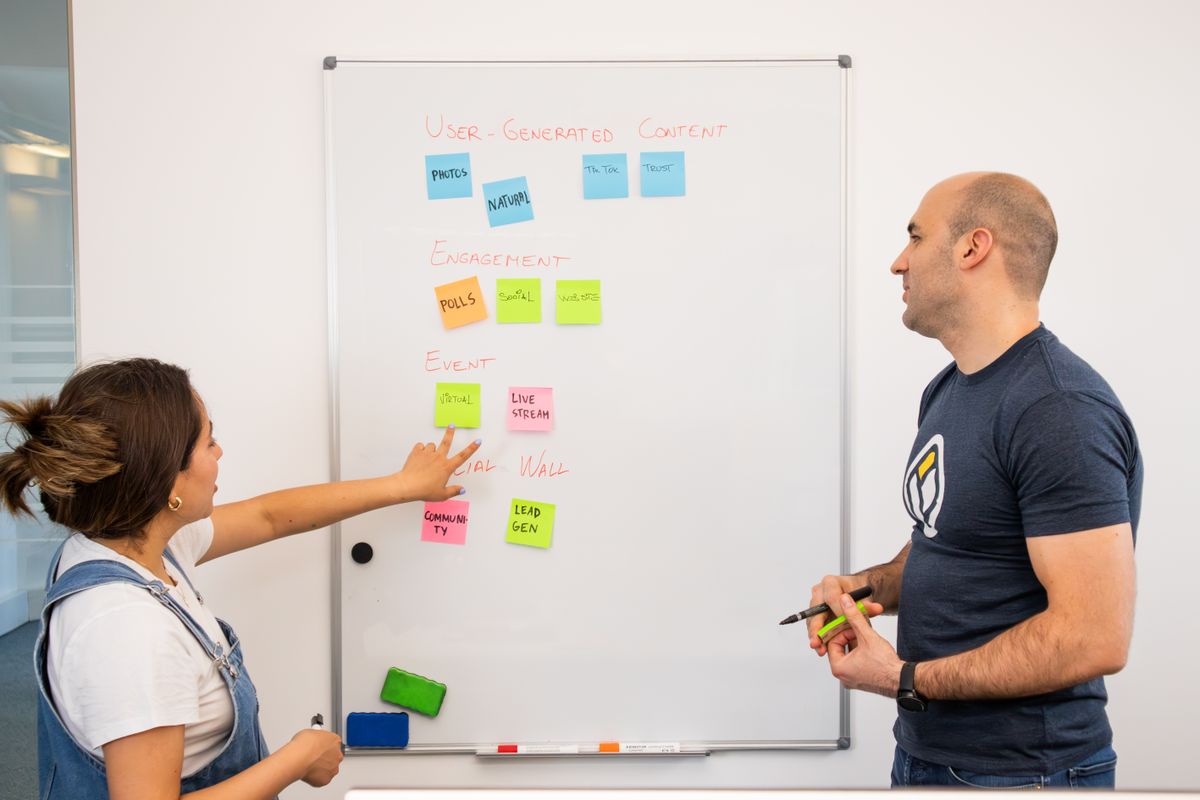 Colleagues mapping ideas on a whiteboard